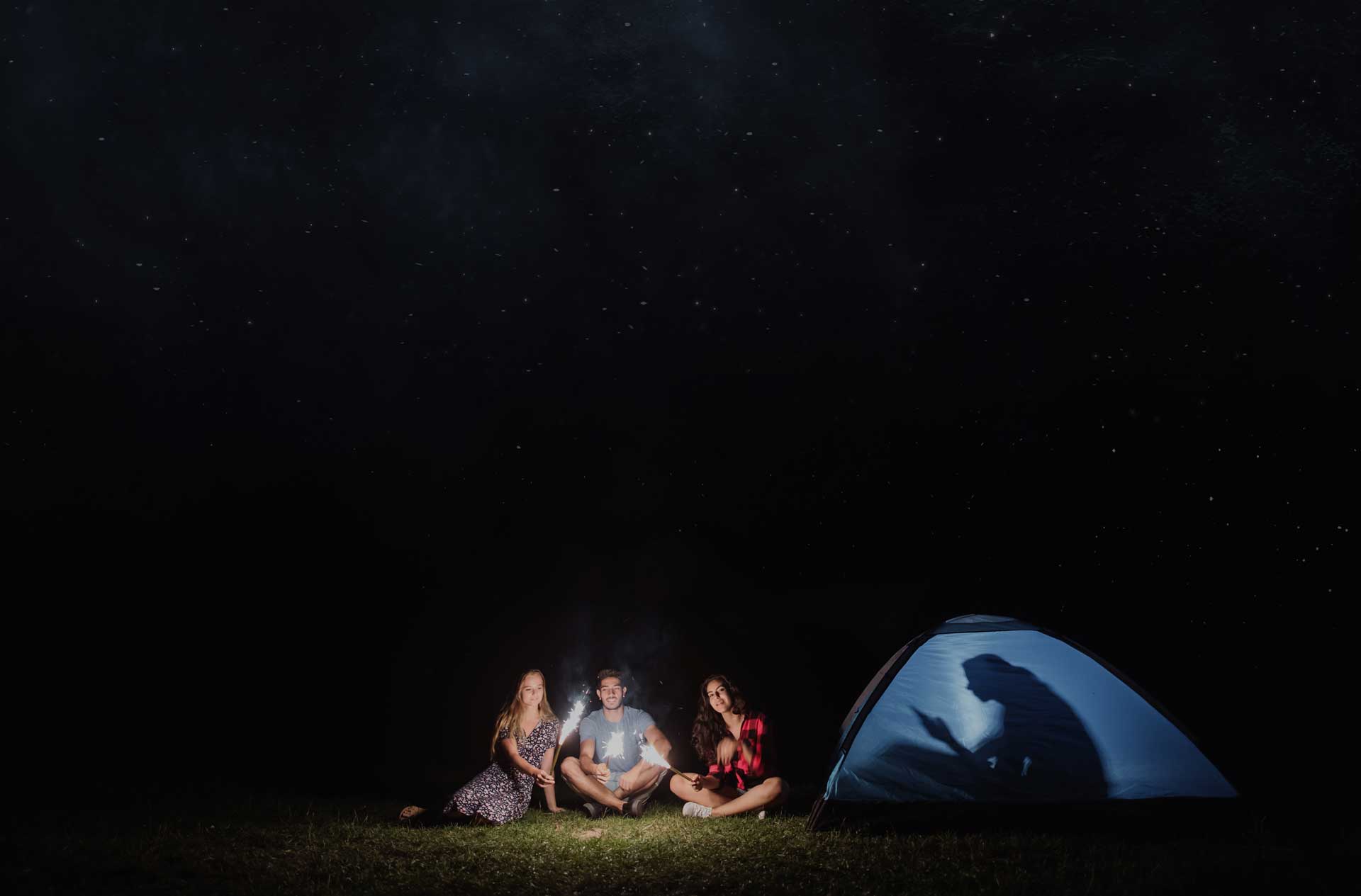 friends-with-sparklers-outdoors-at-dusk-one-with